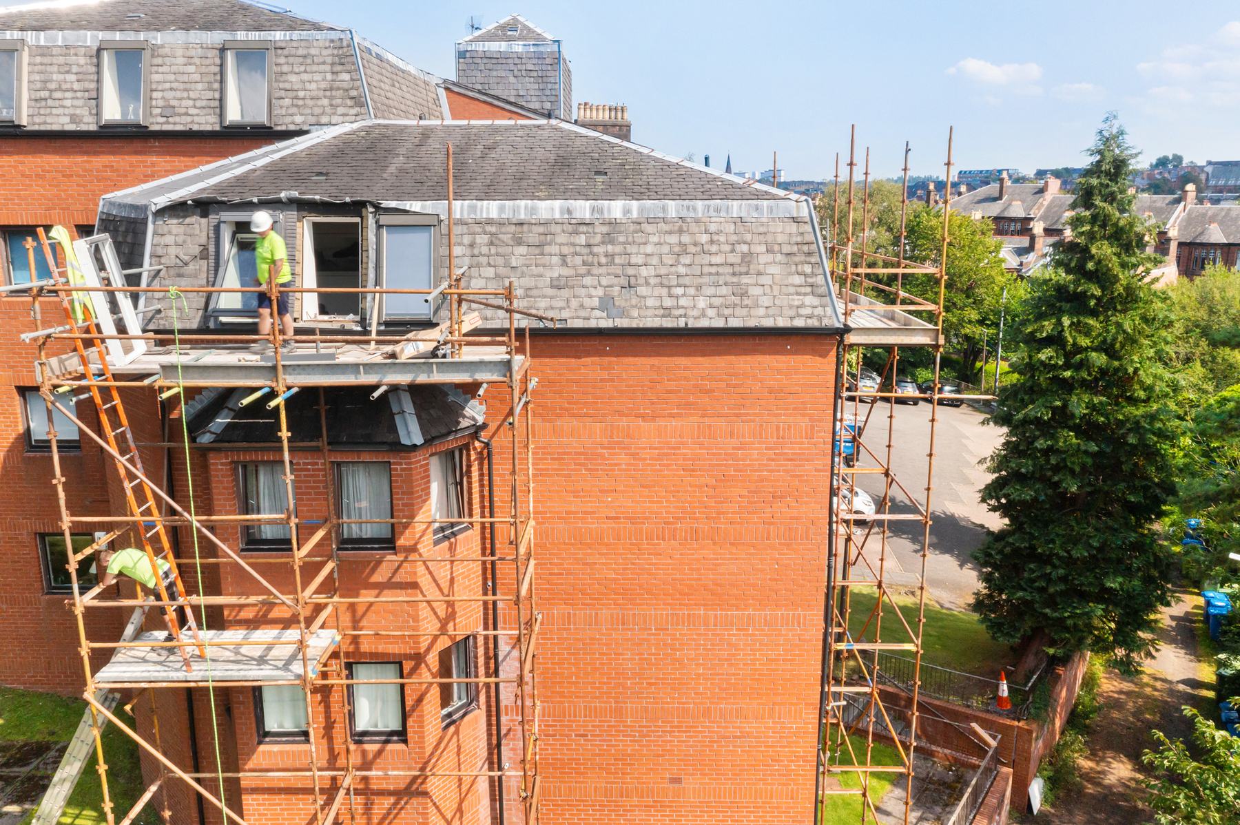 Business exterior photography with scaffolding, red brick building