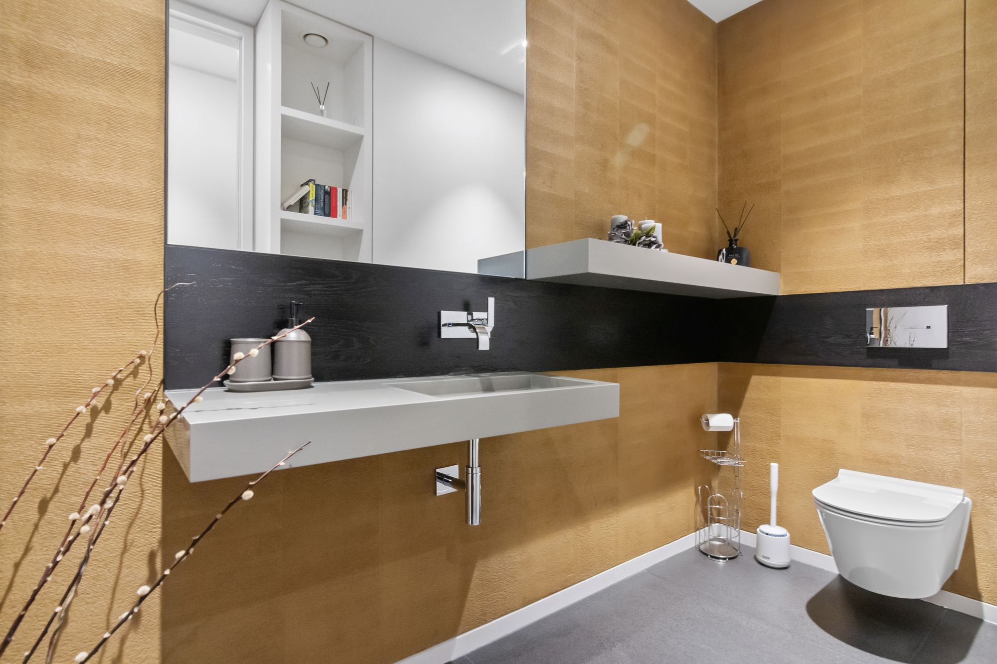 Bathroom with gold textured tiling and marble accents