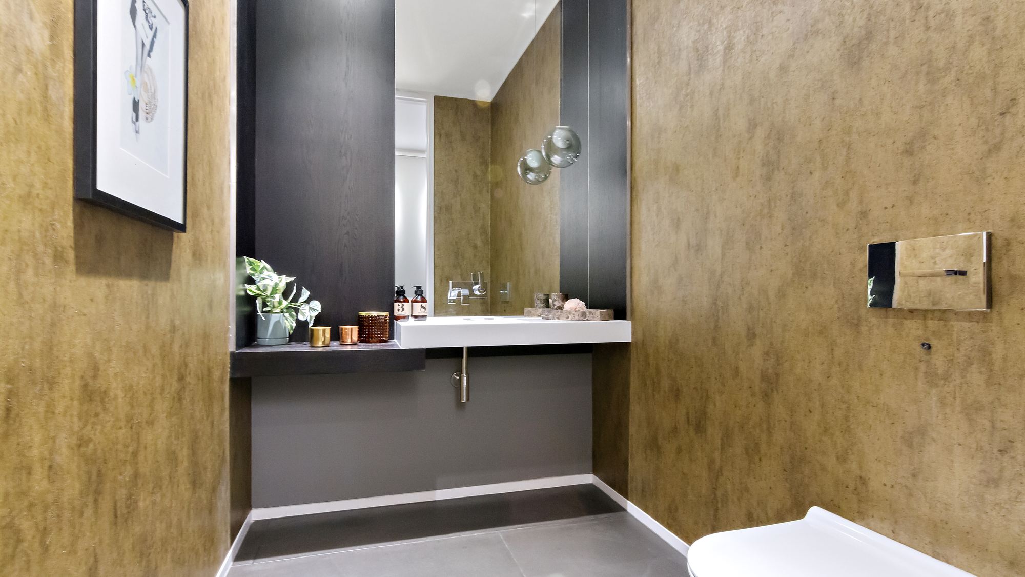 Bathroom with gold tone walls and floating vanity