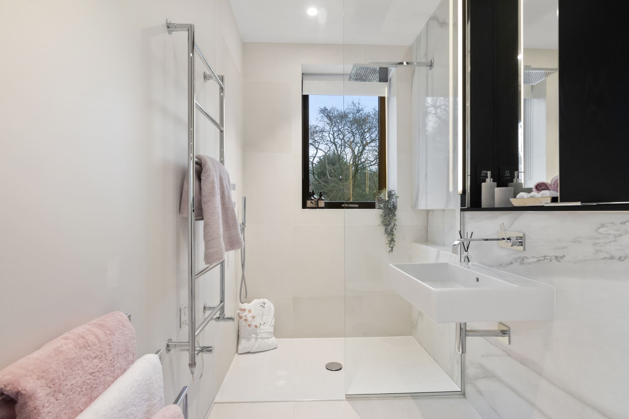 Ensuite bathroom with marble tiling and walk-in shower