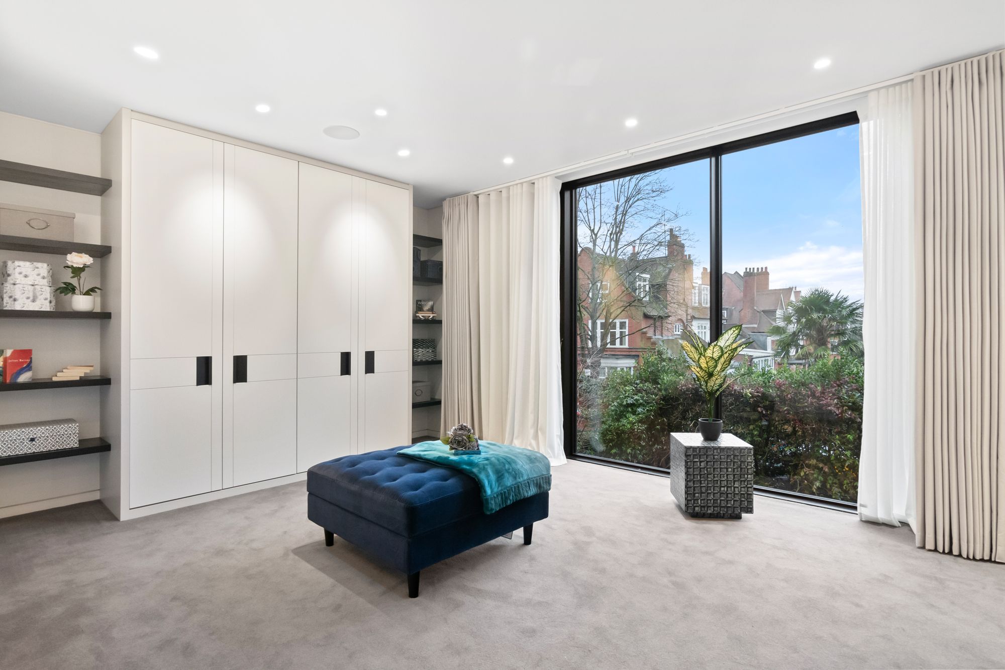 Bedroom with fitted wardrobes and floor-to-ceiling window