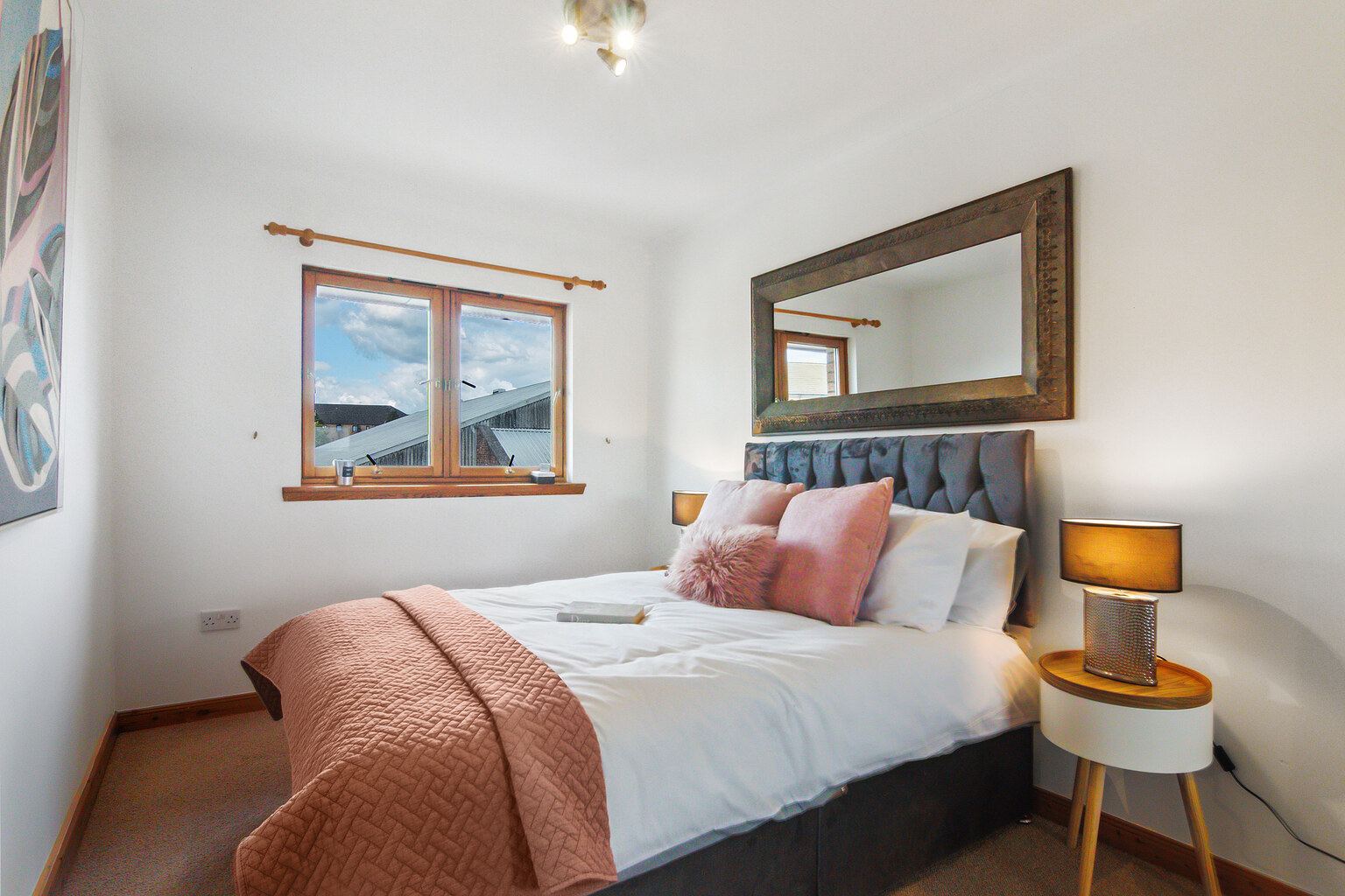 Bedroom with statement mirror above bed