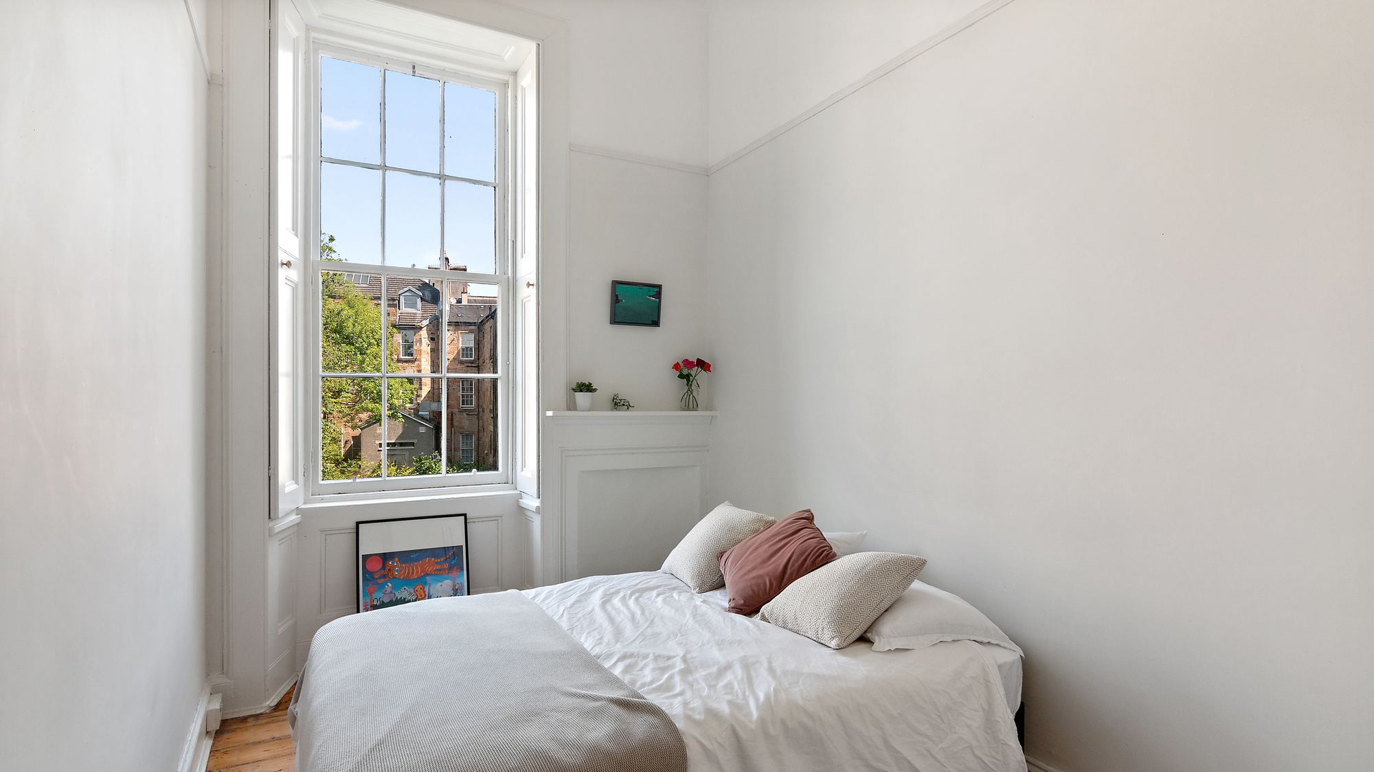 Bedroom with sash window and city view