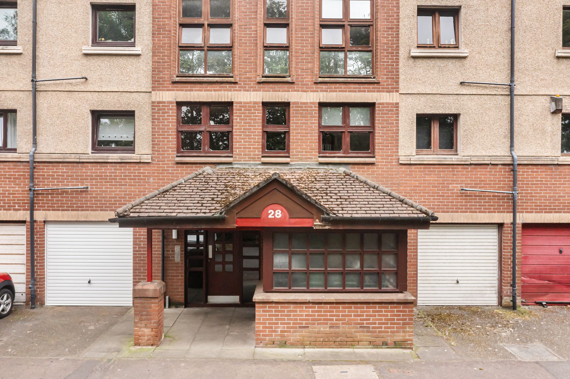 Brick apartment building entrance porch with numbered signage