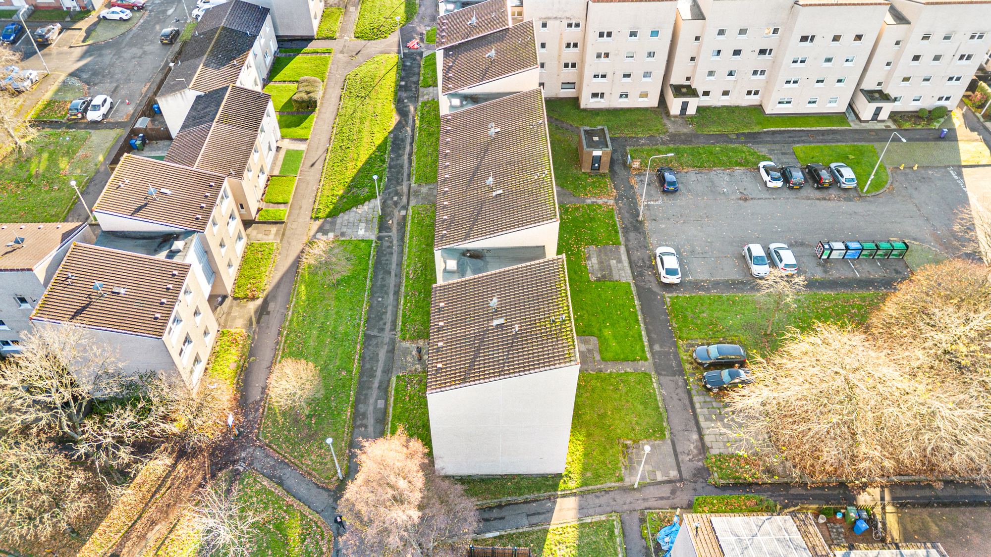Aerial drone photograph of a housing courtyard and parking area