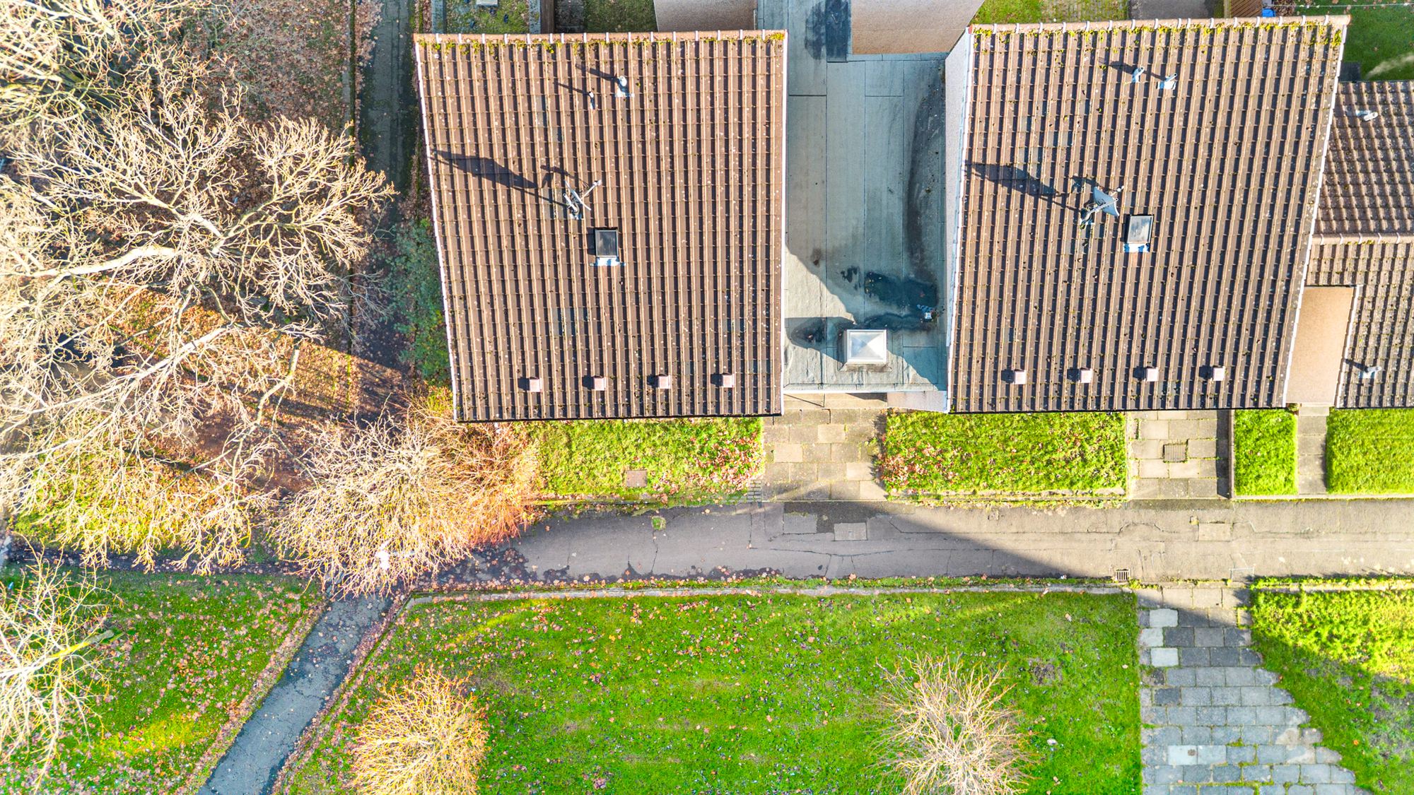 Close aerial drone photograph of pitched roofs