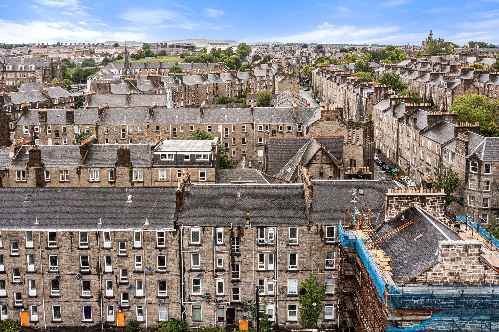 Aerial drone photograph of Dundee tenement rooftops with scaffolding