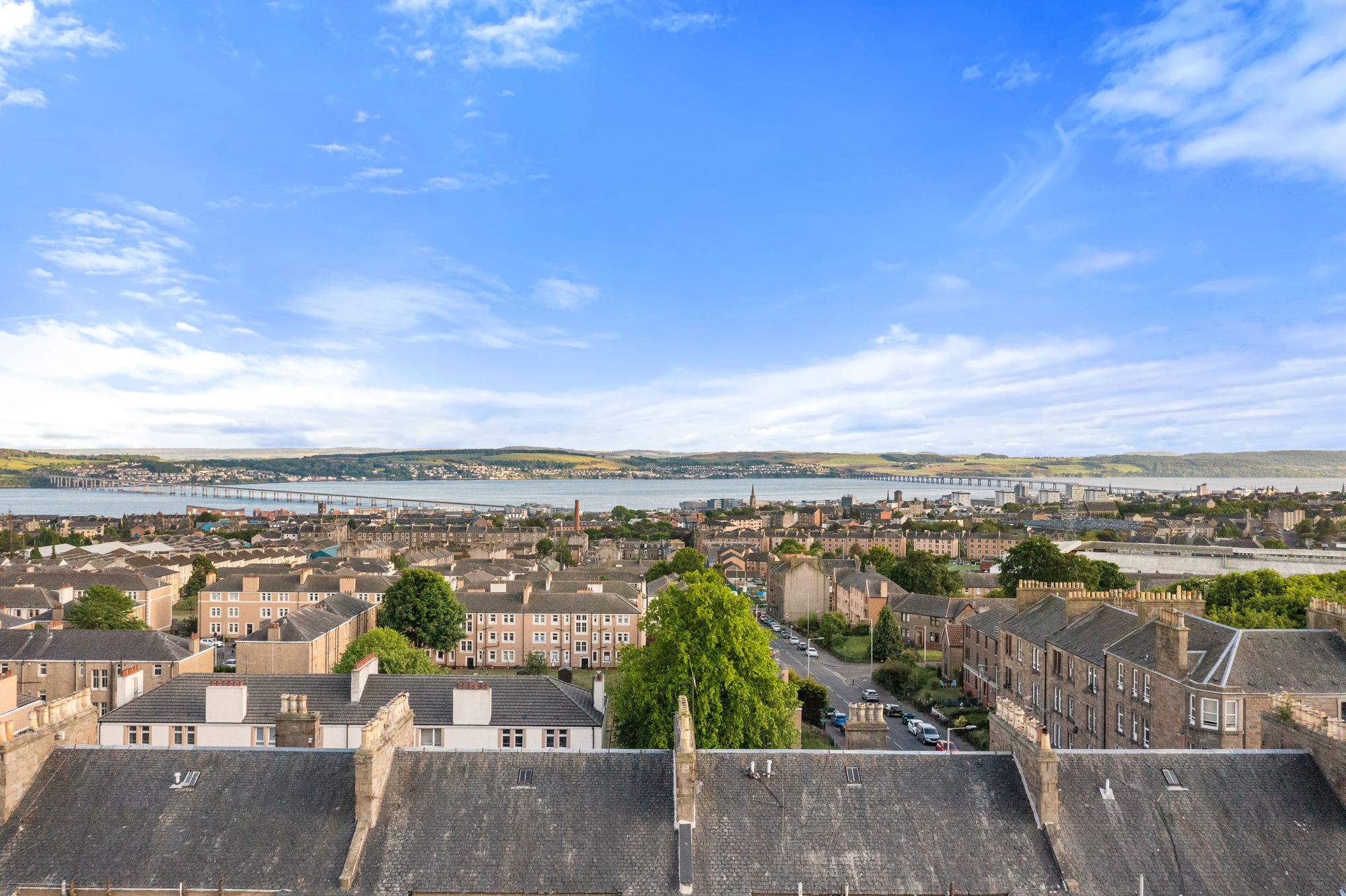 Aerial drone photograph over Dundee rooftops towards the River Tay