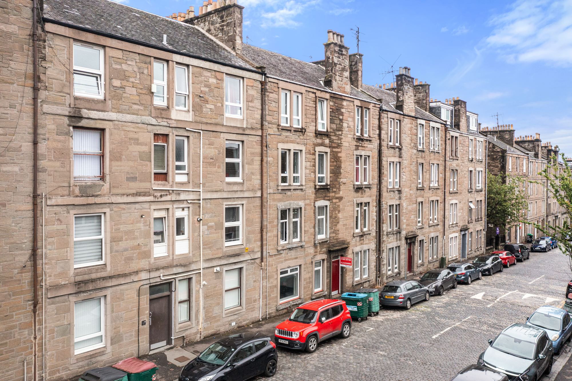 Sandstone tenements along a cobbled street in Dundee