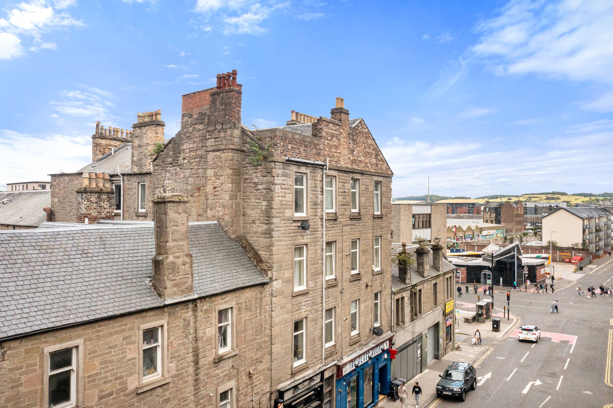 Sandstone corner building overlooking a city street