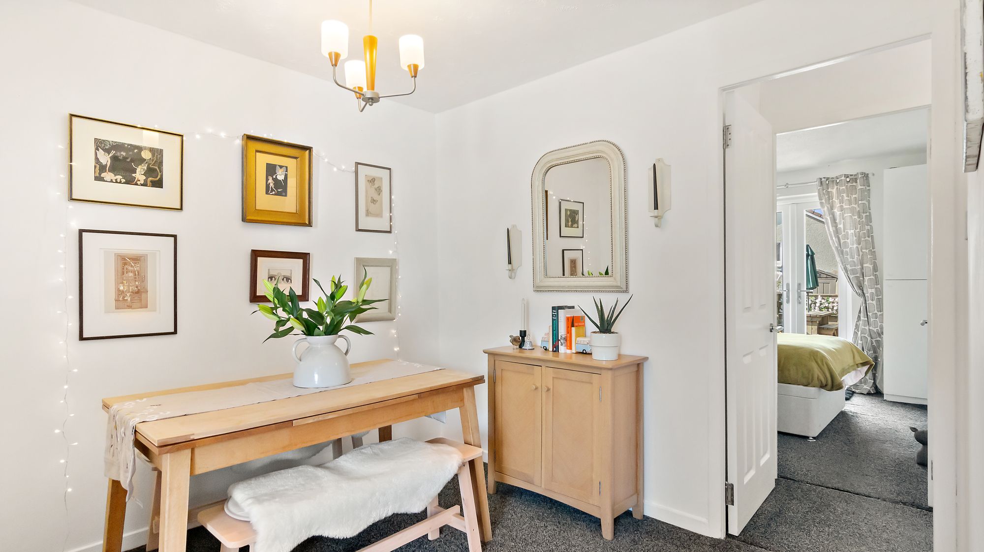 Hallway with gallery wall of framed art and mirror