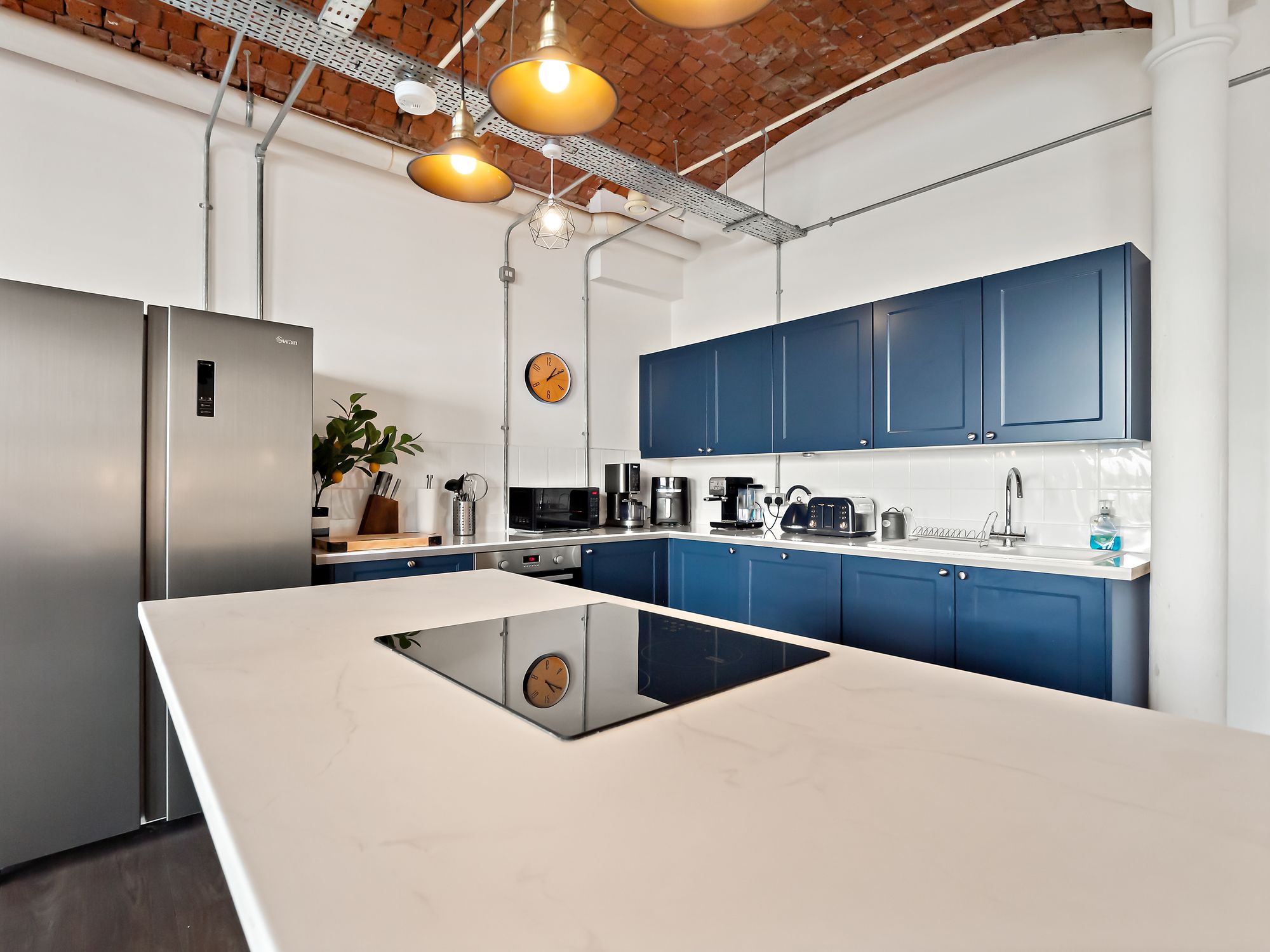 Industrial style kitchen with navy cabinetry