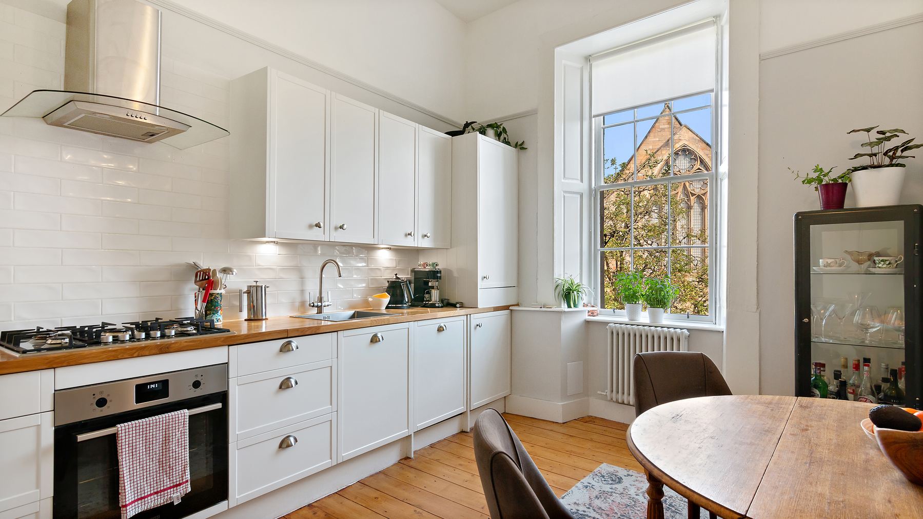 Bright kitchen with wooden countertops and period window