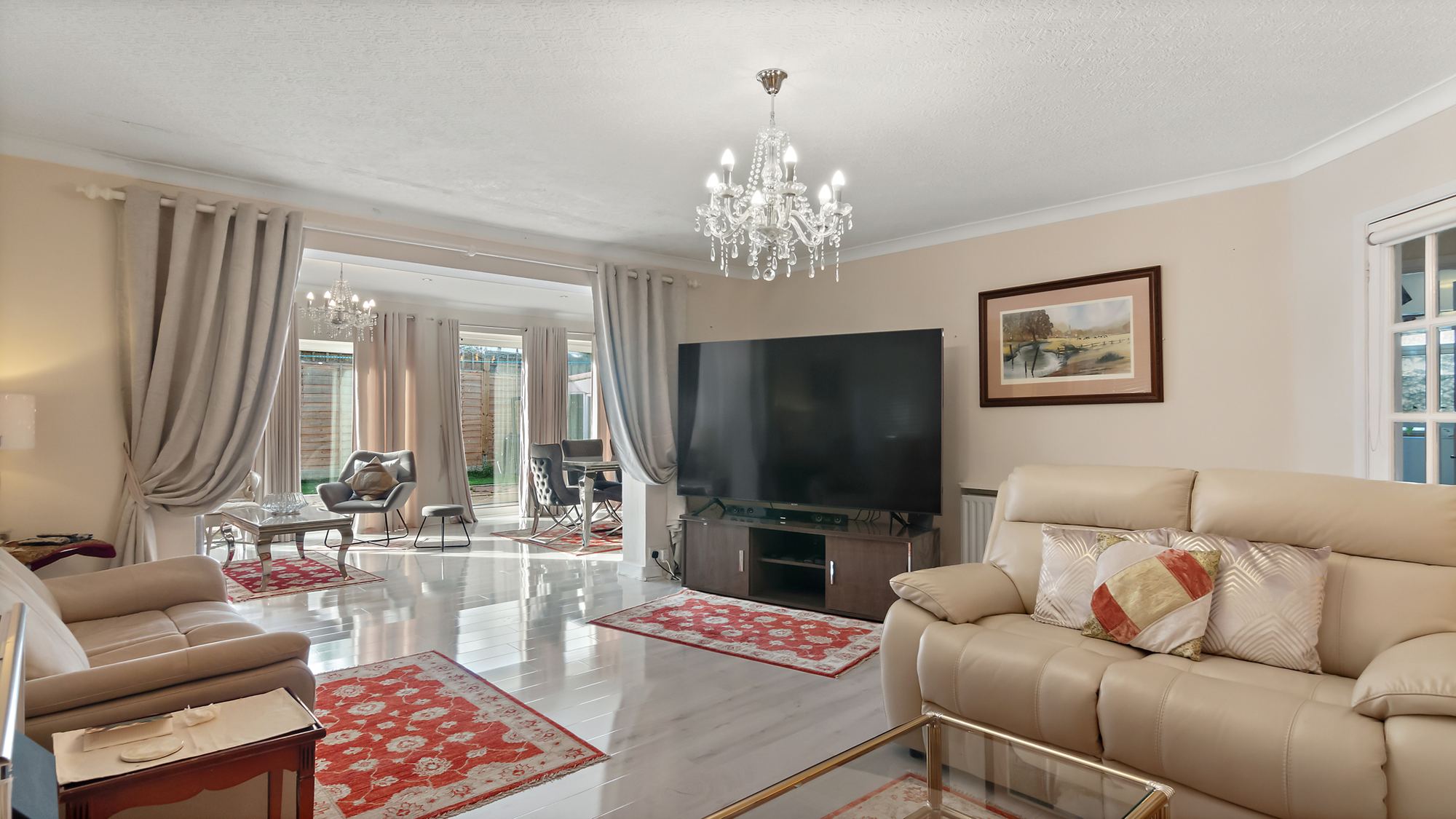 Open-plan living room with crystal chandelier