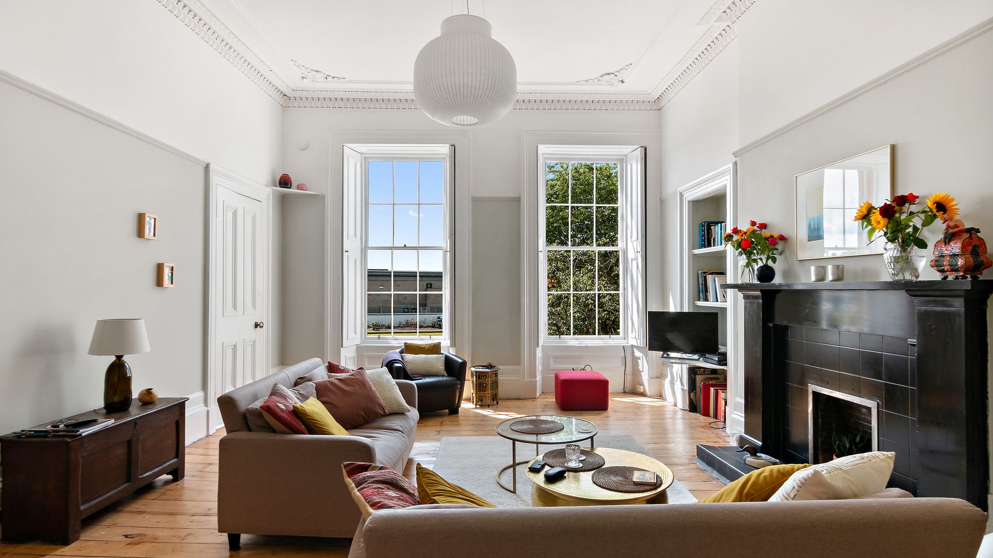 Bright living room with ornate period cornicing and sash windows