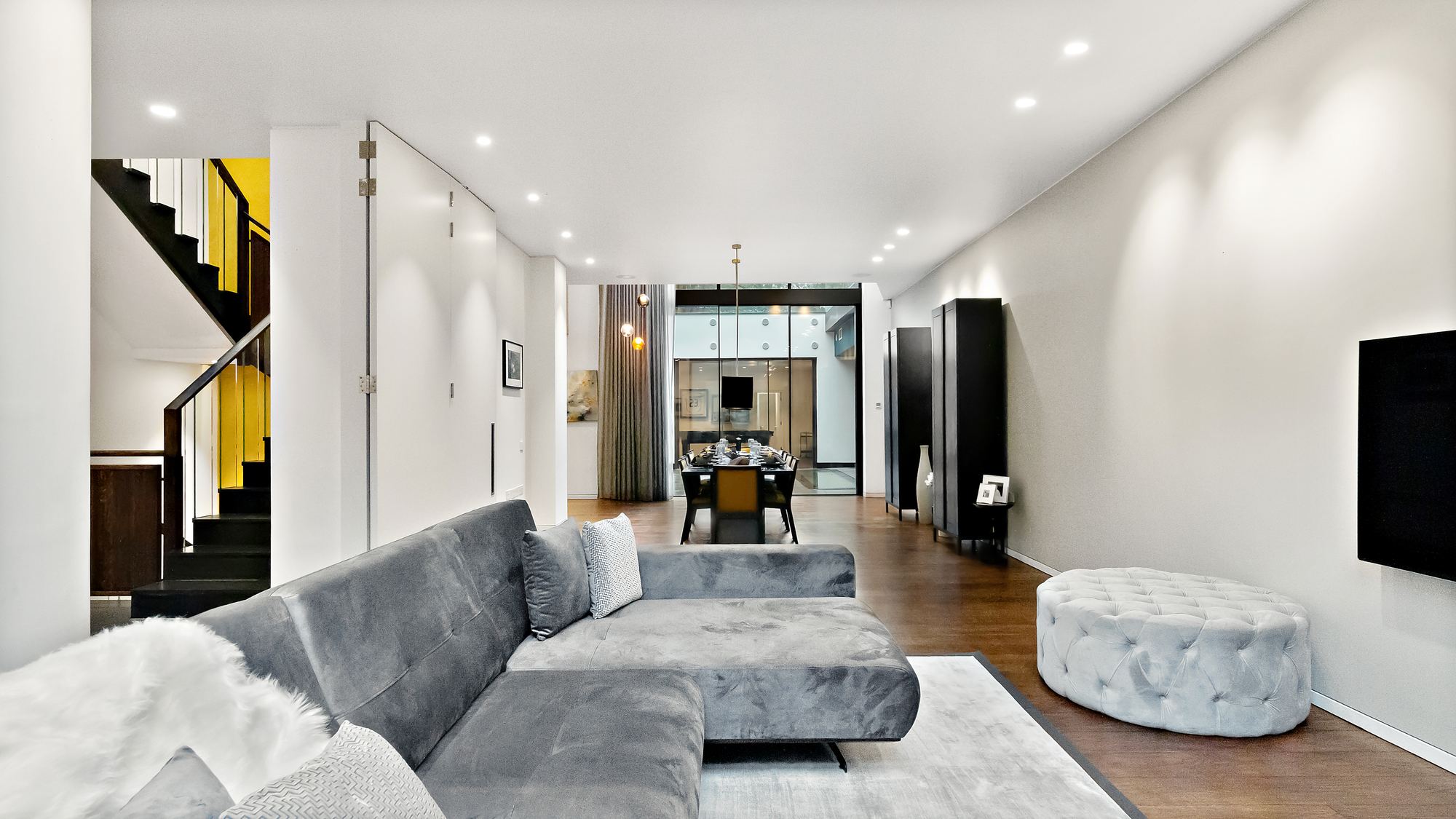 Open-plan living and dining space with staircase