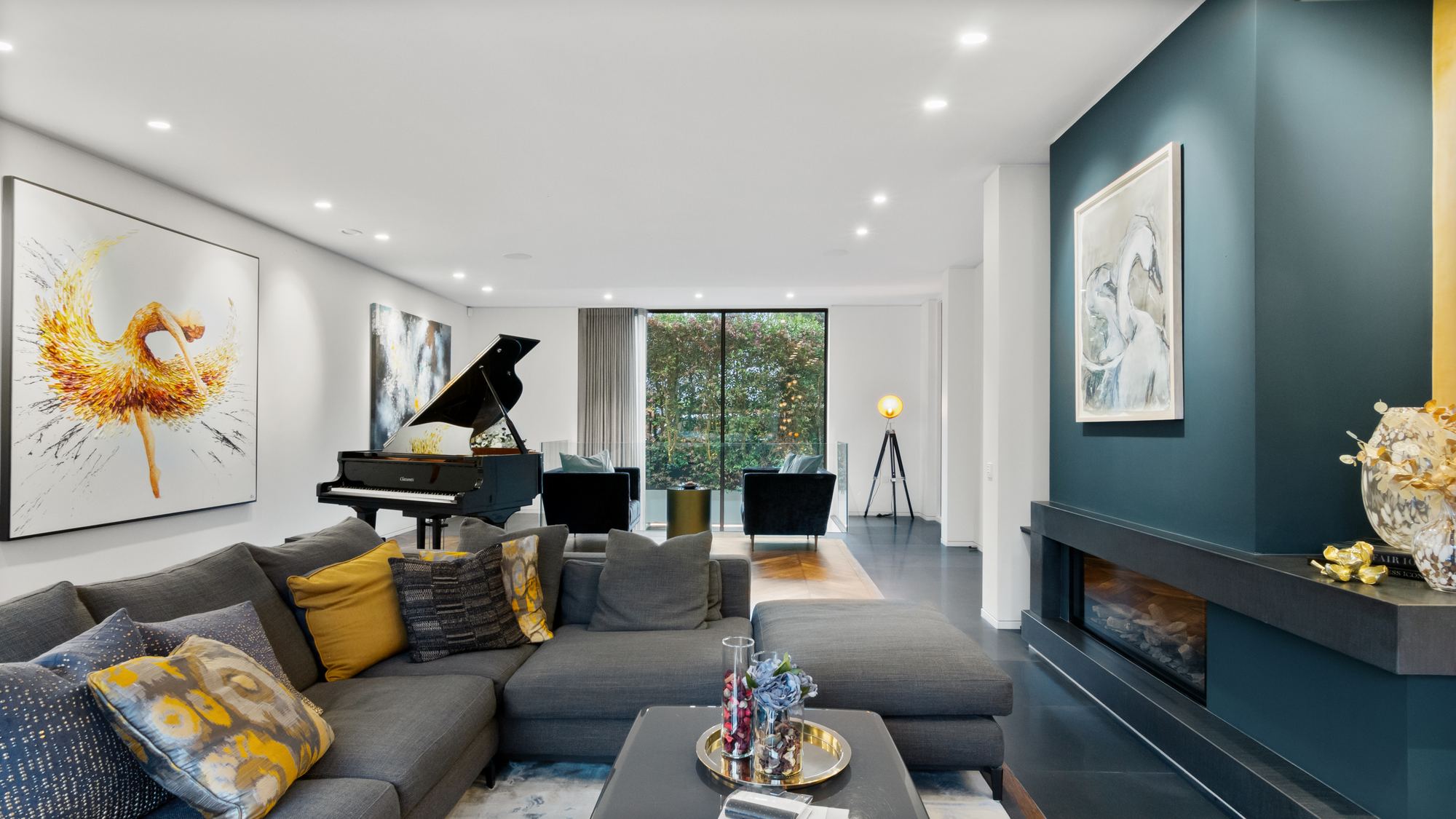 Living room with grand piano and fireplace