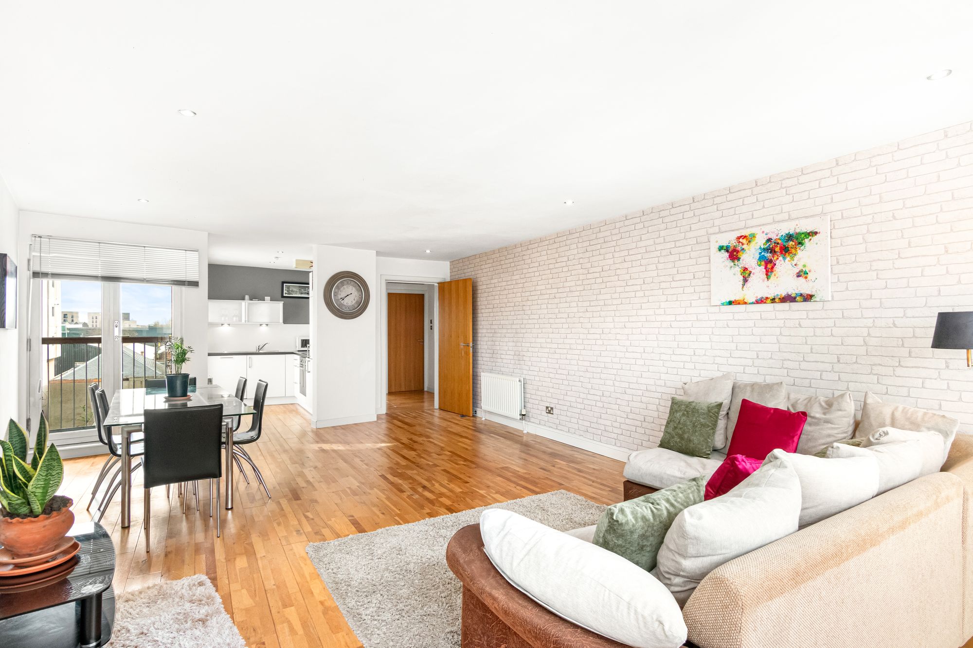 Open-plan living room with exposed brick feature wall