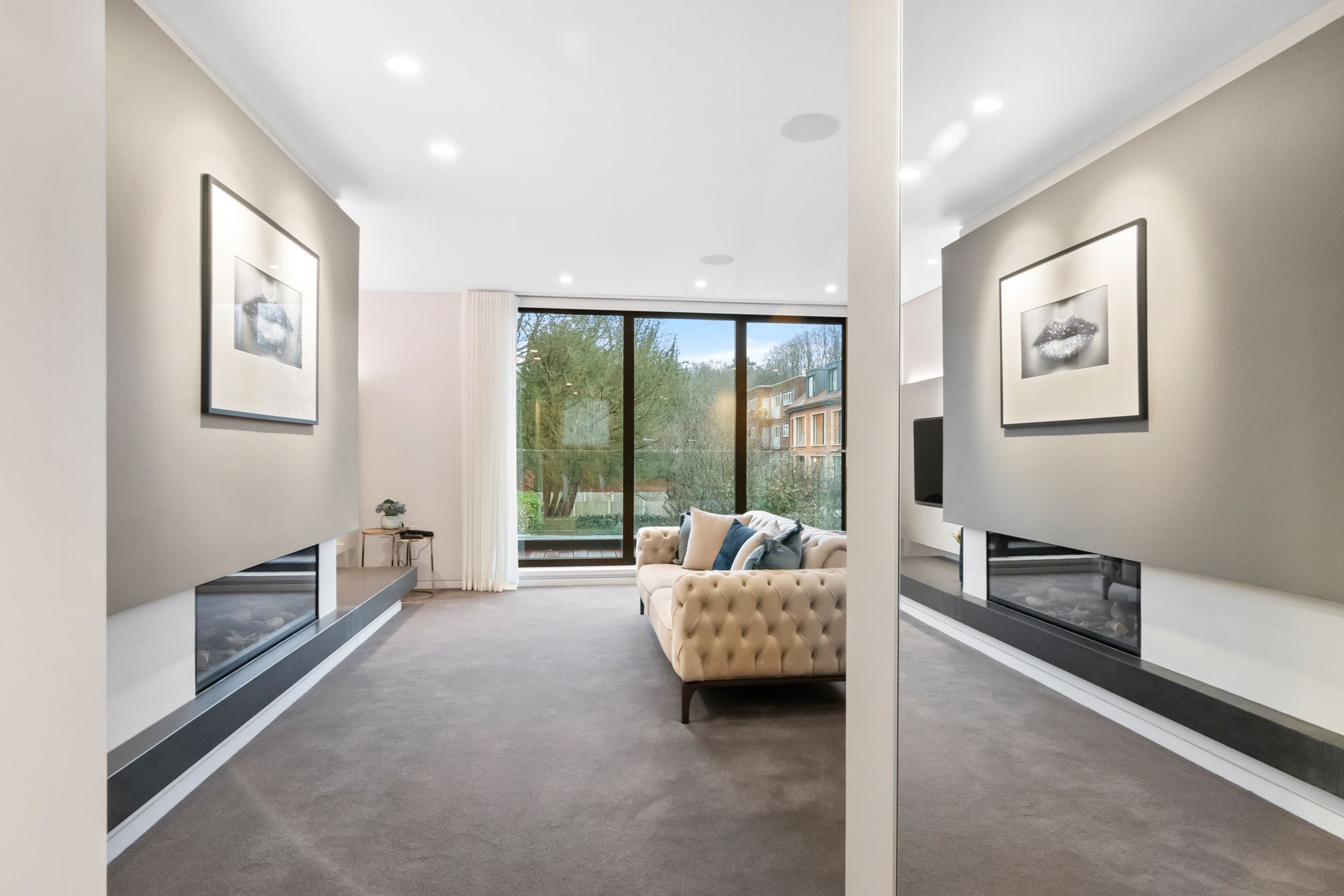 Living room with fireplace and floor-to-ceiling window