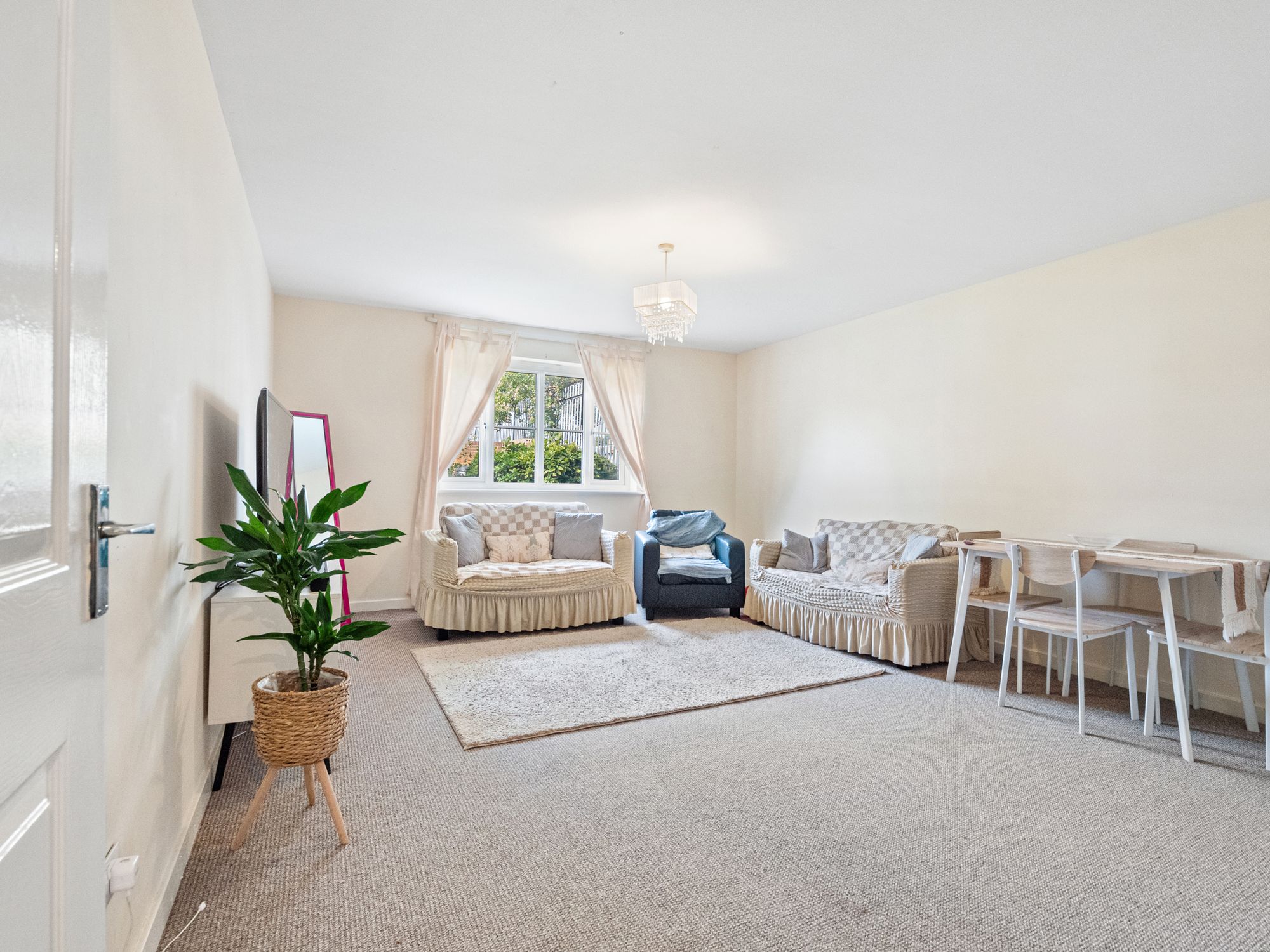 Carpeted living room with soft furnishings