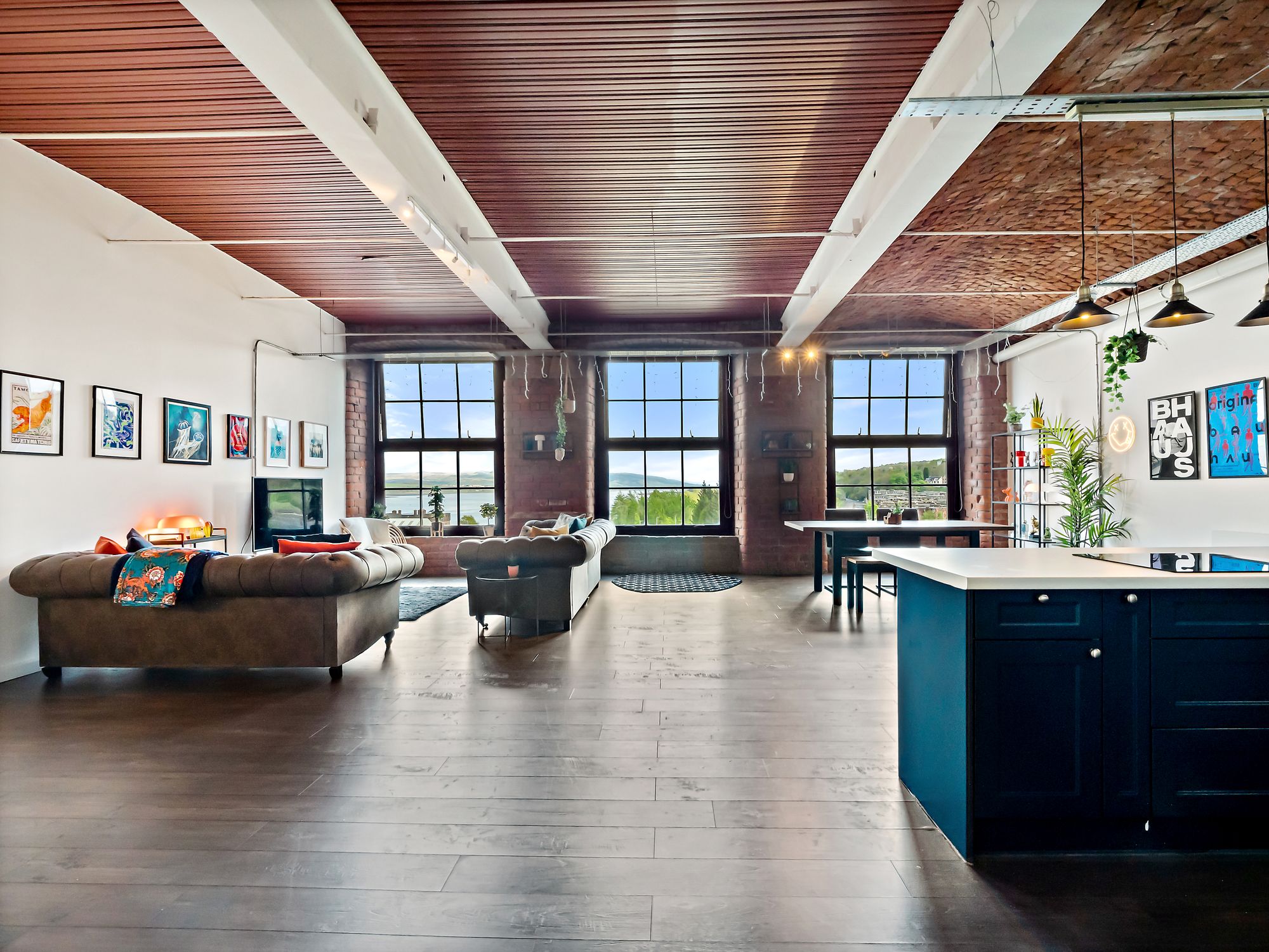 Open-plan loft living room with navy kitchen island