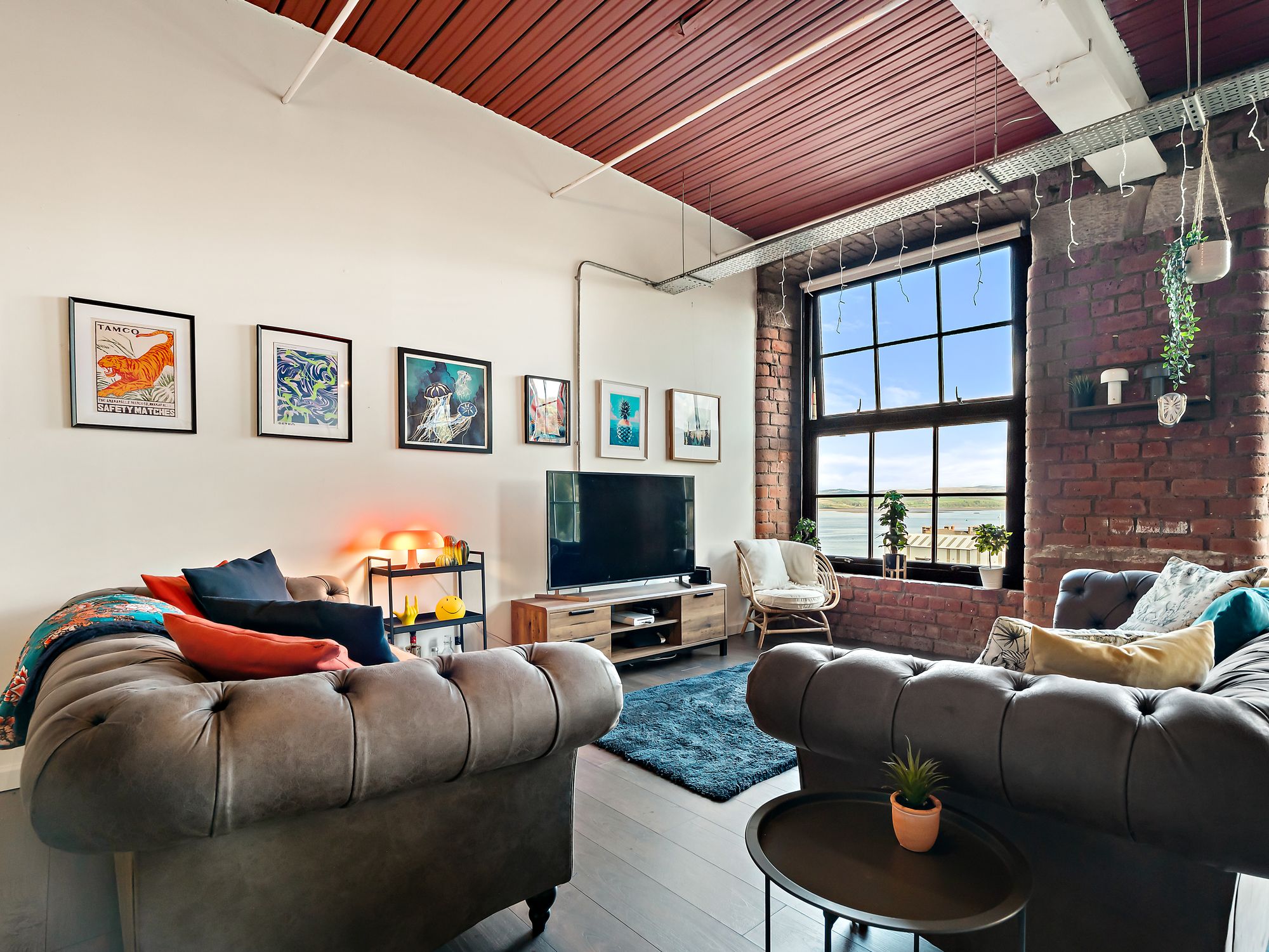 Loft living room with gallery wall of framed prints