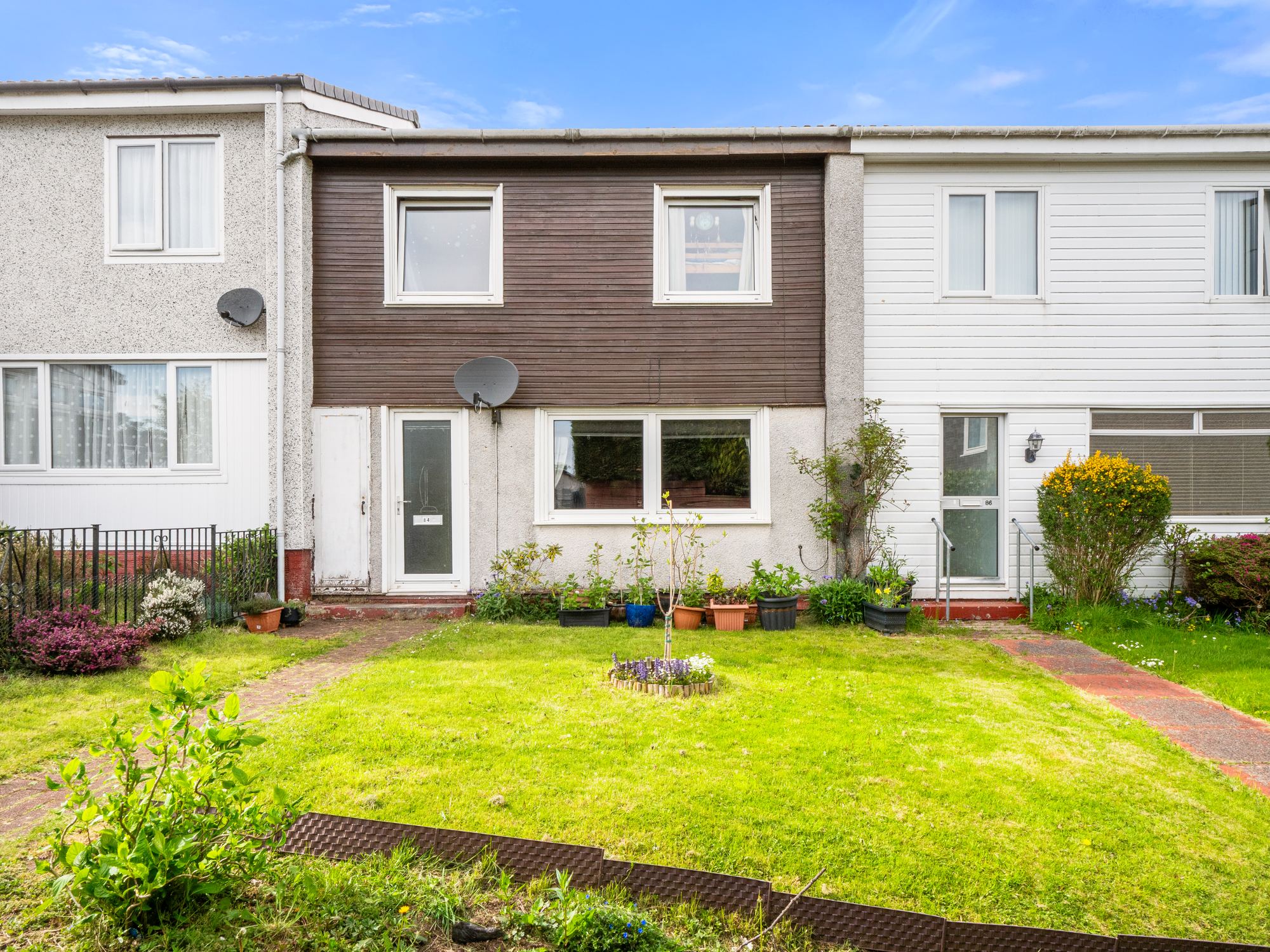 Terraced house with well kept front garden and lawn