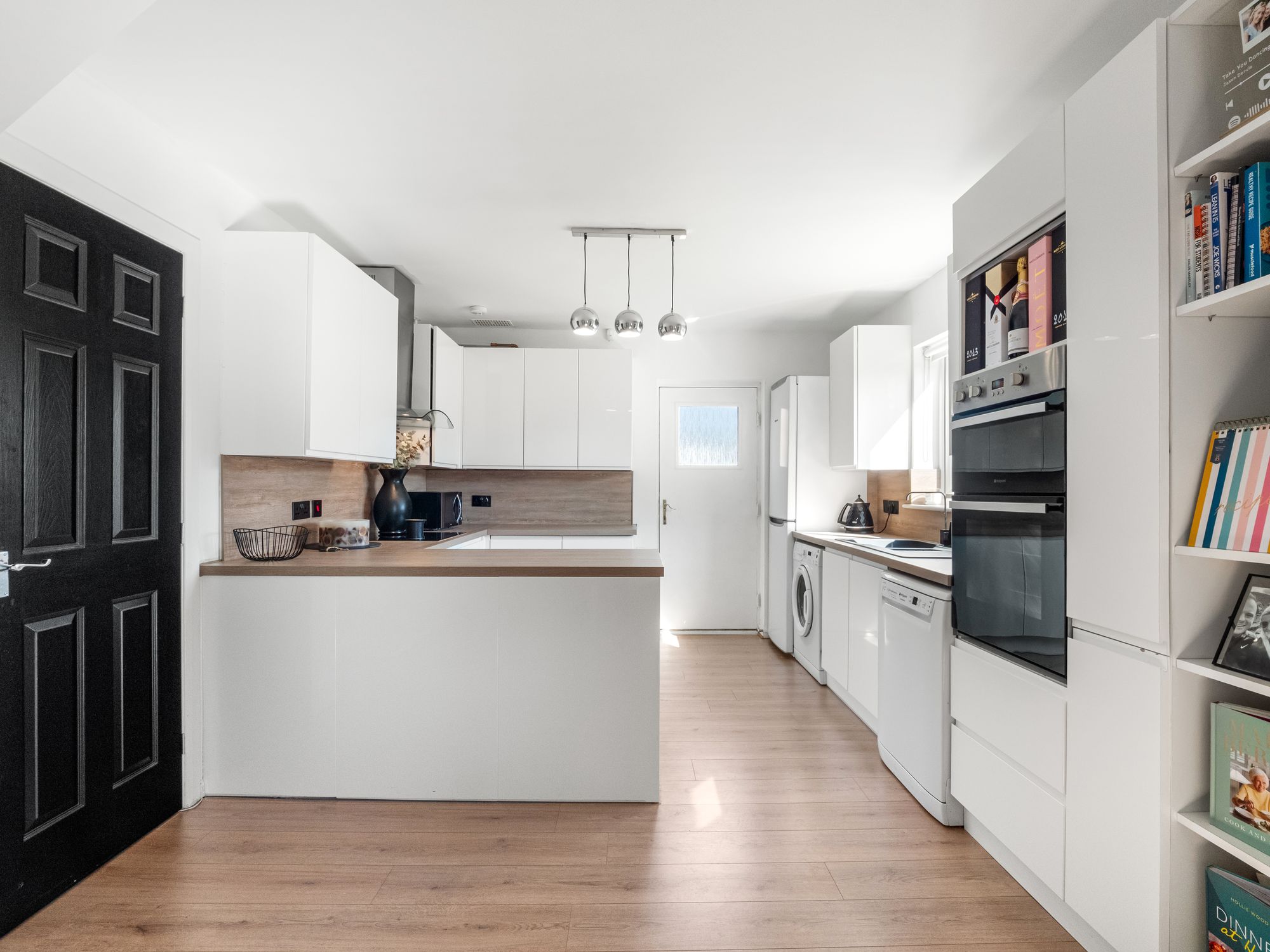 White fitted kitchen with integrated utility appliances